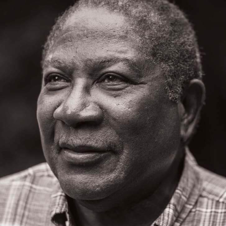 Portrait of a man in a button-down shirt looking out to the left.