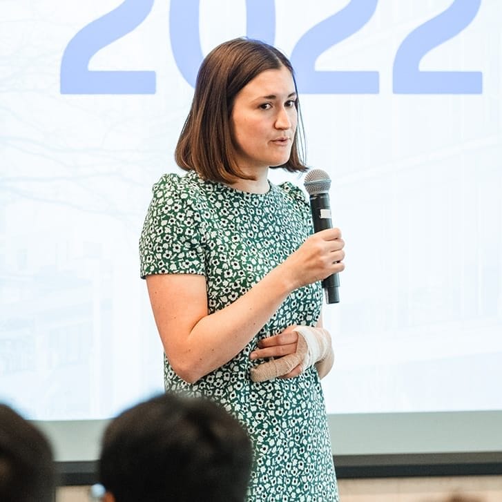 Photo of alumna Sarah Powers speaking at an event.