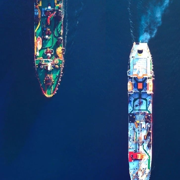 Three cargo ships in the water.