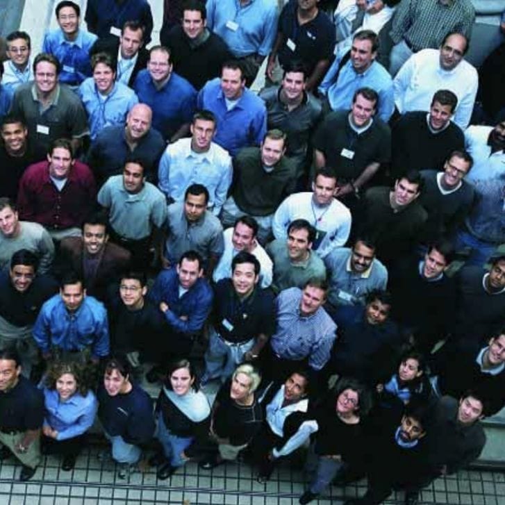 Members of the first Executive MBA class in San Francisco stands on the steps of the San Francisco Federal Reserve building.