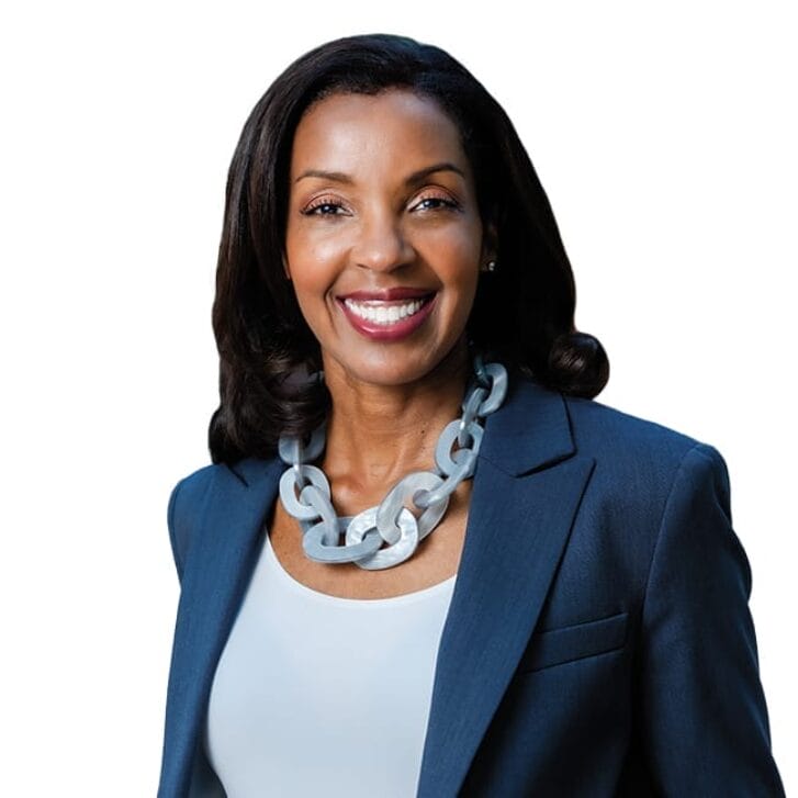 Portrait of Dean Erika James wearing a blue suit jacket, a light blue necklace, and a plain shirt.