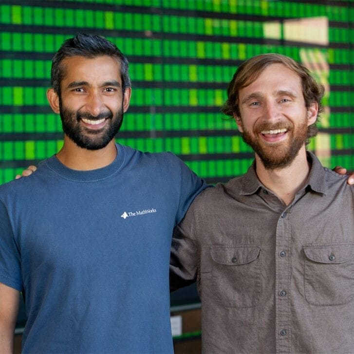 Working Trees founders posing for a photo together in front of a green background.