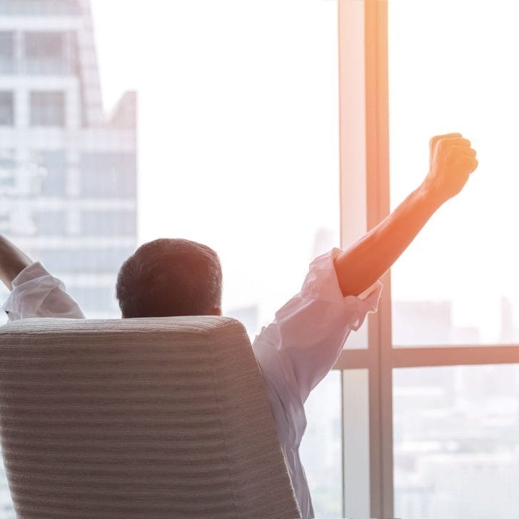 Businessman raising arms