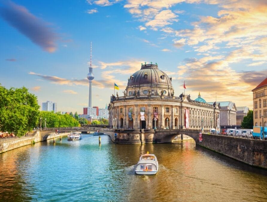 Boat on a river among buildings in Berlin.