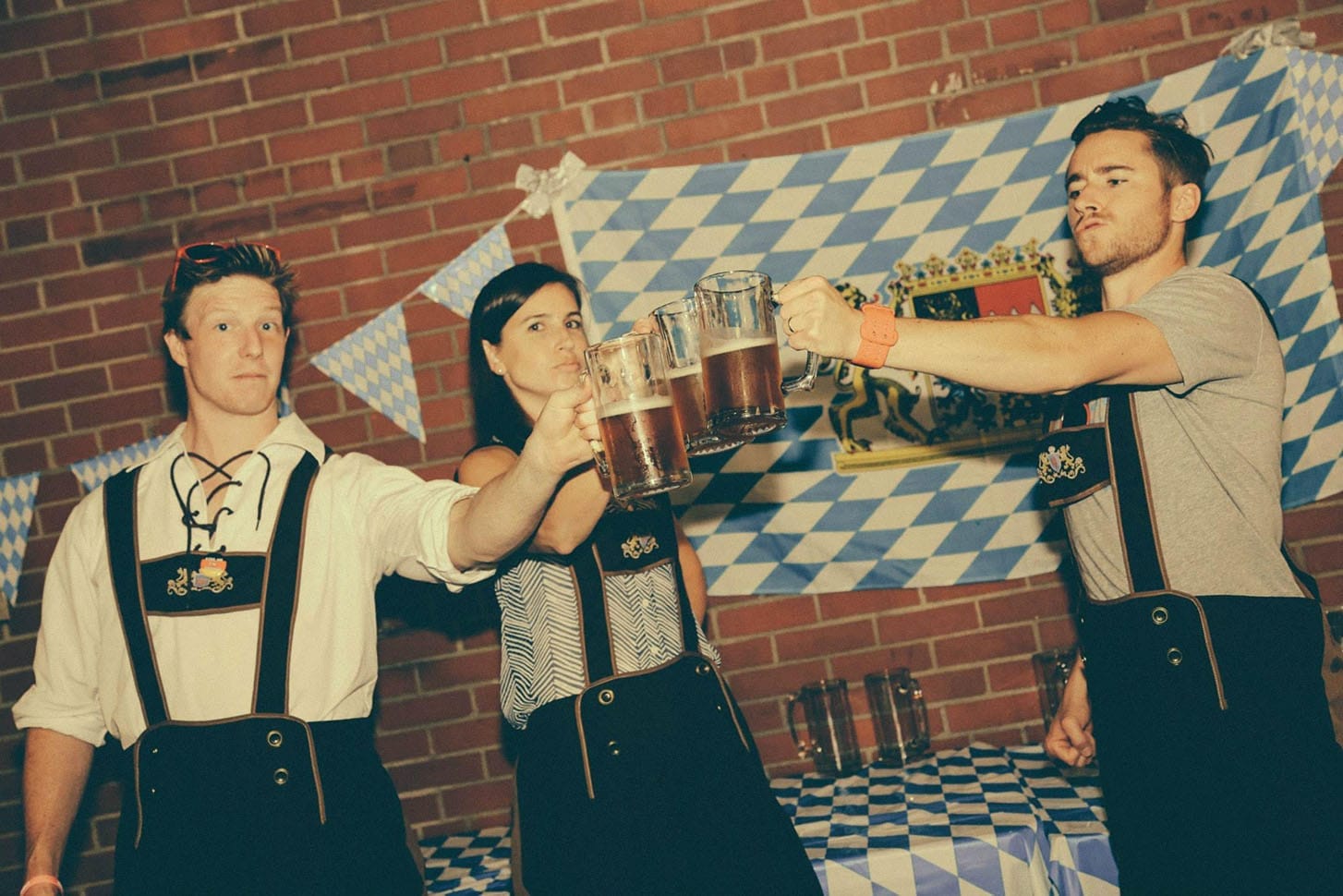 Three people wearing traditional Tracht for Oktoberfest.