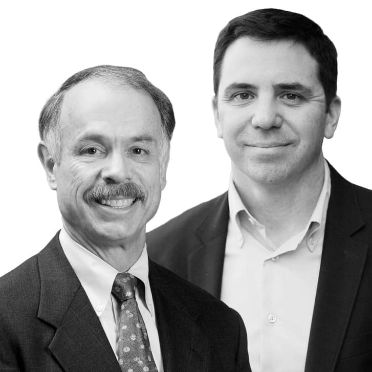 Headshots of two men in white button-down shirts and dark suit jackets.