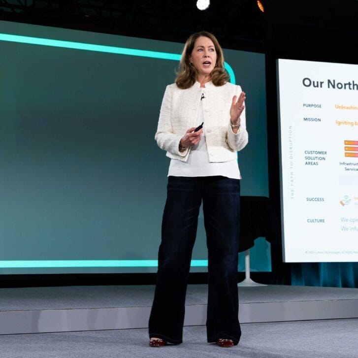 Woman standing on a stage in front of a presentation