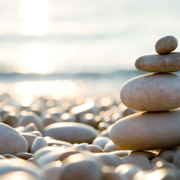 Stones stacked on top of one another on a rocky beach